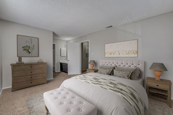 Staged bedroom with tufted headboard and furnishings